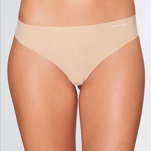 3 pack of Calvin Klein nude invisible thongs XL